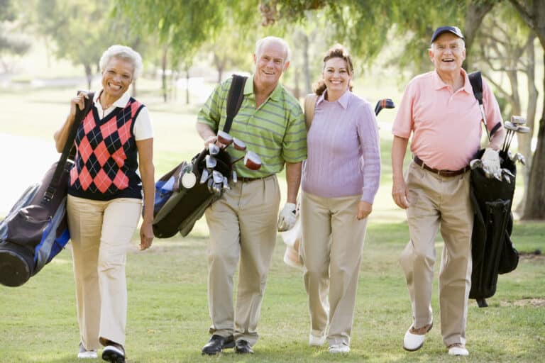 Smiling seniors golfing