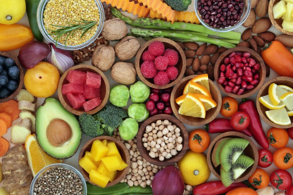 Colorful assortment of fruits, vegetables, and nuts spread out on flat surface