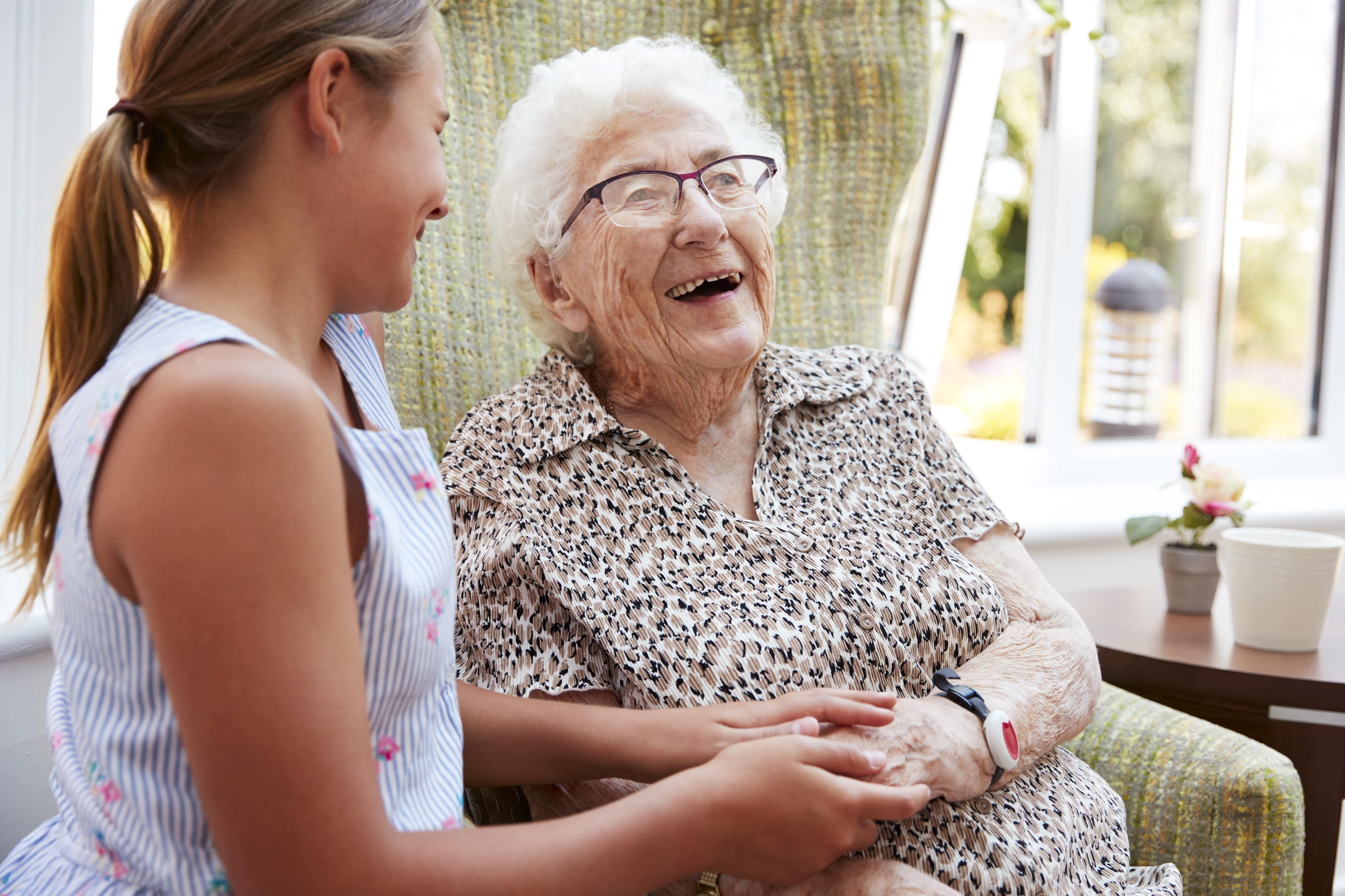 Senior woman laughing with young granddaughter